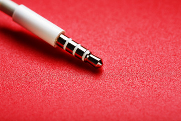 White connector AUX white cable on a red background