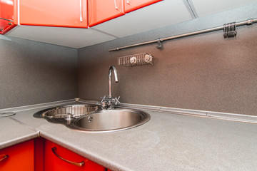The photo of a sink in a The photo of a sink in a  kitchen