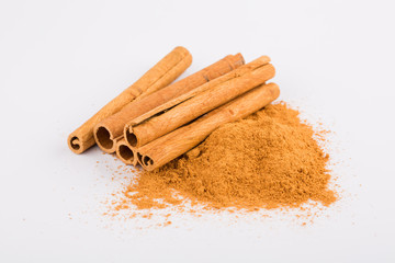 Cinnamon sticks and powder on white background