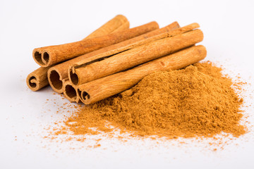Cinnamon sticks and powder on white background