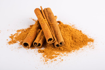 Cinnamon sticks and powder on white background