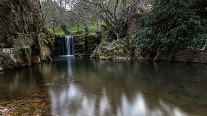 Fototapeta na wymiar waterfalls in a old abandoned mine in extremadura dehesa