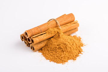 Cinnamon sticks and powder on white background