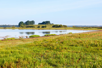 Lake bay on a beach with a hill in the countryside