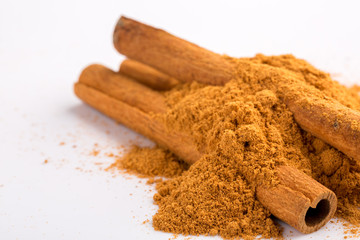 Cinnamon sticks and powder on white background