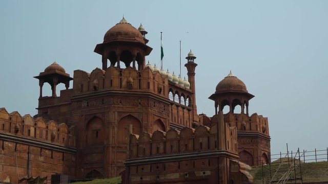 Roofline at the Red Fort (Lal Qila) during the day. There are scaffoldings and railings around the fort and many different building levels. Handheld. Midshot. MS.