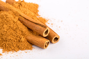 Cinnamon sticks and powder on white background