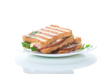 fresh sandwich with vegetables, bacon and cheese on a white