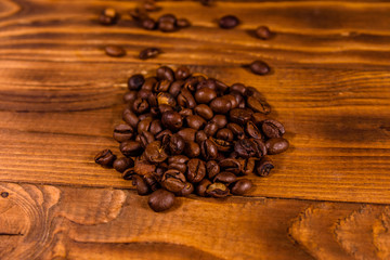 Pile of the coffee beans on wooden table