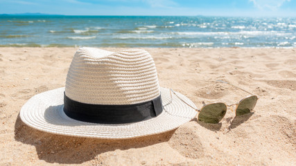 White hat and sunglasses on beach, Summer concept
