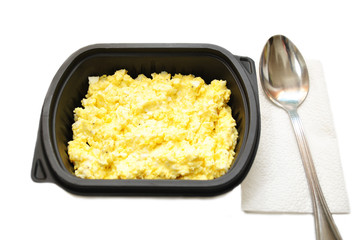 Egg Salad in a Plastic Container Over a White Background