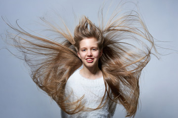 Teen girl with long hair flying in air