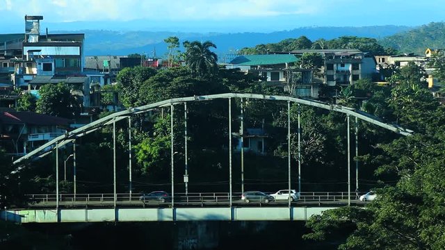 Busy bridge with traffic, cars, taxis and busses driving over the metal bridge