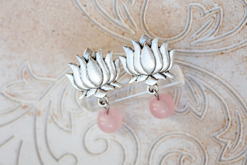 silver earrings in shape of lotus blossom and mineral rose quartz gemstone