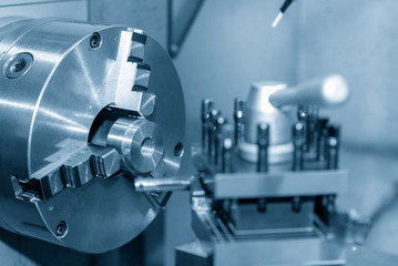 The lathe machine cutting the metal ring parts. The metal working manufacturing process.