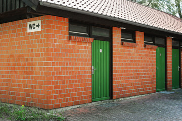 public toilet restroom building or outhouse with WC sign in Germany