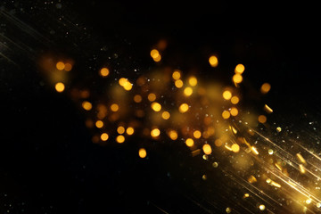 glitter vintage lights background. black and gold. de-focused