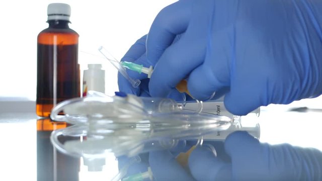 Doctor Hands Protected with Special Gloves Checking Perfusion Needle