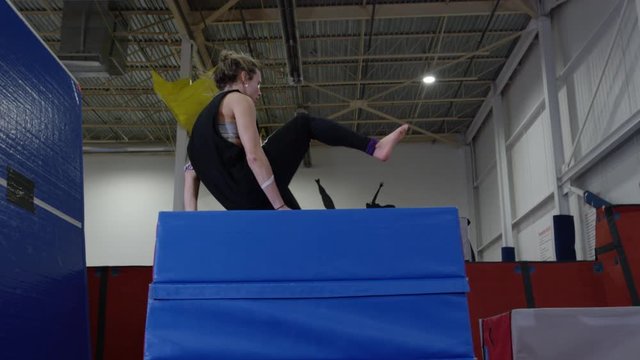 Female gymnast training in the gym for parcour and trampoline
