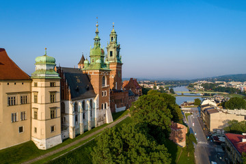 Krakow, Poland. Wawel Cathedral at historic royal castle and Vistula River with a bridge.  Aerial view in sunrise light early in the morning in summer