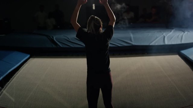 Young woman training in the gym for trampoline gymnastics and parcour