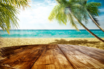 Summer landscape of beach ocean and palms. Wooden old table of free space for your decoration. 