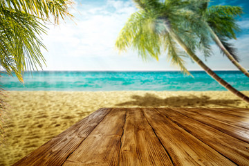 Summer landscape of beach ocean and palms. Wooden old table of free space for your decoration. 