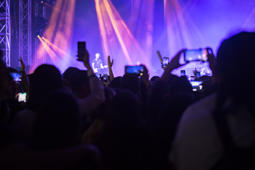 hands to the skies of people dancing and having fun at the live music concert