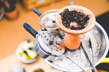 clay head of a shisha with used tobacco