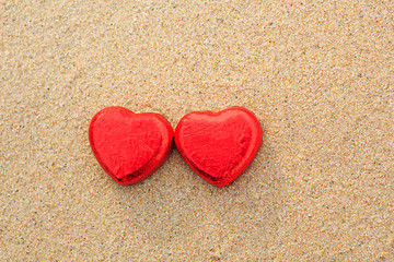 Fototapeta premium Chocolate color Lovely red heart on the beach. Background is a natural in real place, creative Valentine's Day Concept, tropical style background made in Phuket, Thailand.
