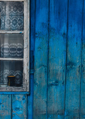 old wooden blue wall near window white frame