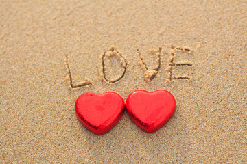 Fototapeta premium Chocolate color Lovely red heart on the beach. Background is a natural in real place, creative Valentine's Day Concept, tropical style background made in Phuket, Thailand.