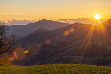 Sunset over the Slovenian landscape. With hills and valley in the middle. Horizontal photo from hill Lisca, Slovenia, Europe. With beautiful sun rays.