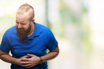 Naklejka na ściany i meble Young caucasian hipster man wearing blue shirt over isolated background with hand on stomach because nausea, painful disease feeling unwell. Ache concept.