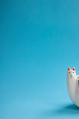 head of white Llama mug on empty blue background. Vertical with copy space for text or design. Trendy animal accessories and kitchen ware