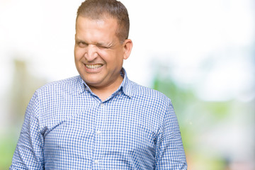 Middle age arab business man over isolated background winking looking at the camera with sexy...