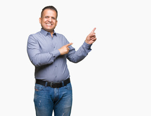 Middle age arab business man over isolated background smiling and looking at the camera pointing with two hands and fingers to the side.