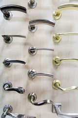 Modern metal door handles in a hardware store