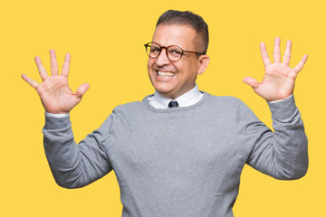 Middle age bussines arab man wearing glasses over isolated background showing and pointing up with fingers number ten while smiling confident and happy.