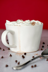White mug of cocoa or coffee and cream with delicious drip