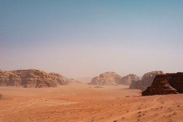 Fototapeta na wymiar Desert hill, huge rock mountain and blue sky in Wadi Rum