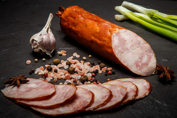 smoked ham sausage with sliced pieces, garlic and onion