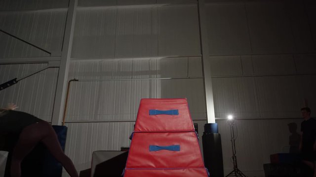 Young woman training in the gym for trampoline gymnastics and parcour