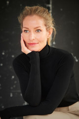 Close-up studio portrait of attractive blond woman in casual clothes