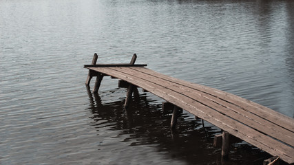 Close up of old, wooden dock or jetty in lake