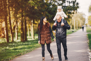 Cute family walking in a autumn park. Mother with little daughter