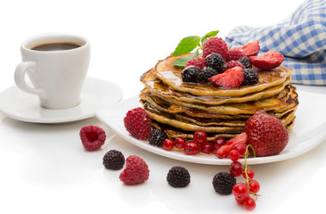 Delicious pancakes with berries and maple syrup on a white background