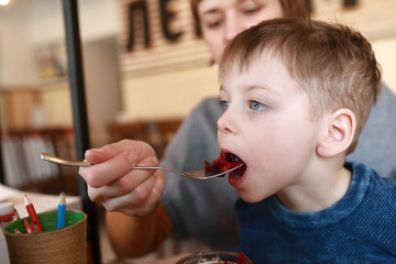 Child eating salad of beetroot