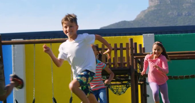 Front view of mixed-race schoolkids playing in the school playground 4k
