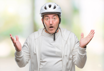 Handsome senior cyclist man wearing bike helmet over isolated background very happy and excited, winner expression celebrating victory screaming with big smile and raised hands